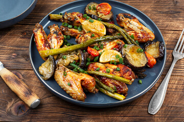 Baked chicken wings with asparagus and eggplant.
