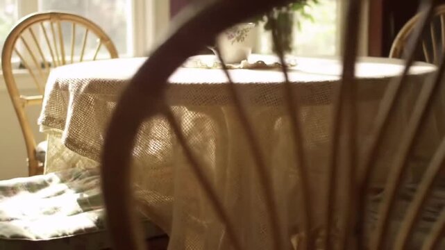 Warm morning light illuminates a delicate teacup on a lace-covered table, evoking peaceful domestic bliss.