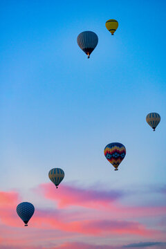 Colorful hot air balloons flying over Cappadocia at sunrise