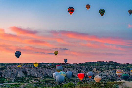Colorful hot air balloons flying over Cappadocia at sunrise