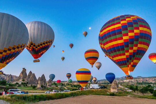 Colorful hot air balloons flying over Cappadocia at sunrise in Turkey