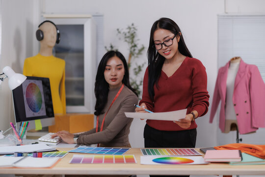 Fashion designers working with color palettes and drawings in their studio - Powered by Adobe