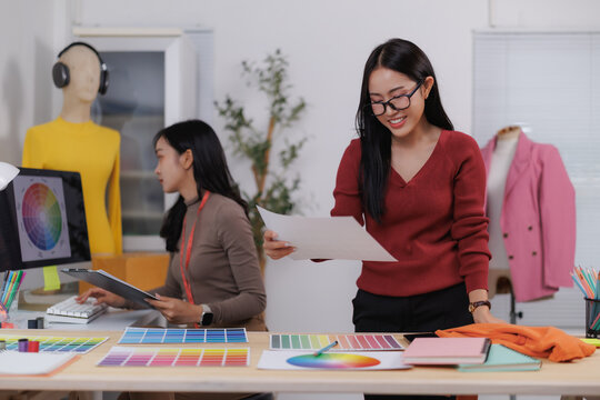 Fashion designers working with color swatches and clothing prototypes