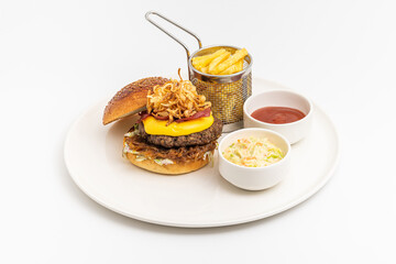 Delicious gourmet burger with cheddar cheese, fried onions, coleslaw and fries