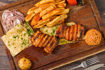 Boneless grilled chicken cutlet served with fries, lavash, onion and bulgur