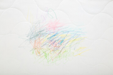 Drawn colorful scratches lines with markers on white mattress cloth. Closeup. Draw of naughty little kid. Top down view.