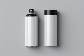 Two spray cans, white with black tops, on gray background