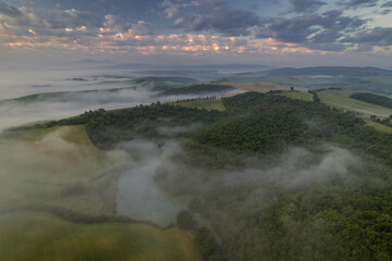 Springtime in Tuscany: rolling green hills, blooming wildflowers, golden light, and peaceful countryside scenes