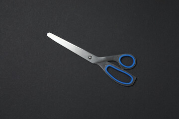 Scissors on black background, flat design. Place for text.
