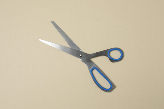 Scissors on beige background, flat design. Place for text.
