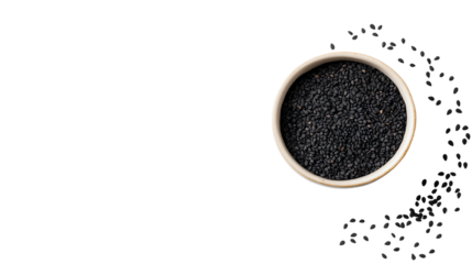 Black cumin seeds in a bowl, scattered around, on a white background.