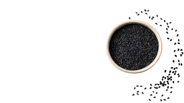 Black cumin seeds in a bowl, scattered around, on a white background.