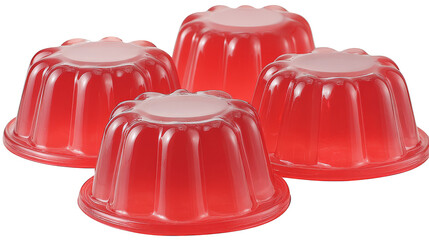 A close-up of four red jelly desserts in fluted cups, isolated on a white background.