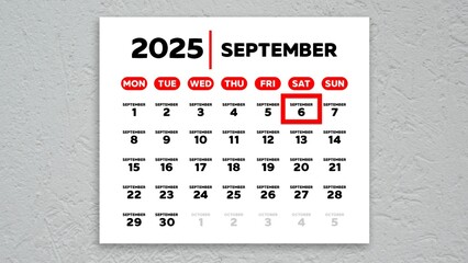 The date September 6th marked with a red cursor on the wall calendar 2025