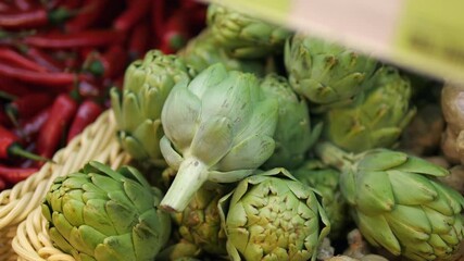  A Close-up of artichokes in a wicker basket. Fresh vegetables. The first 10 keywords should be stable.