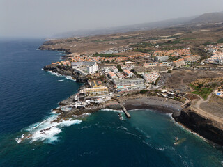 Coastal city with beach and hotel resorts, aerial view