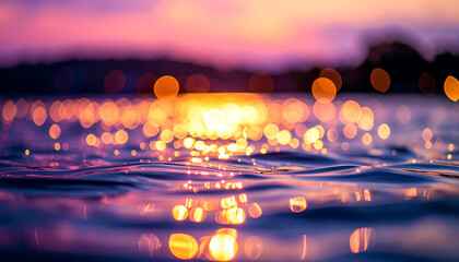 Sunset reflected on calm water, shimmering lights, bokeh effect.