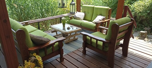 Wooden terrace with cozy garden furniture.