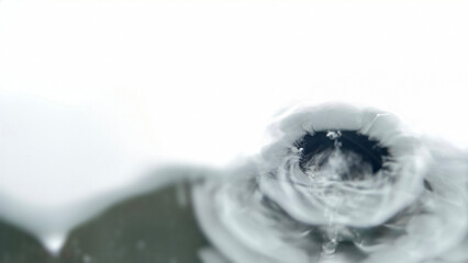 Mesmerizing close-up of a blurred water surface, featuring soft, undulating ripples that form elegant, luminous curves.