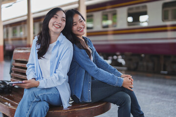 Two young women waiting for train at railway station