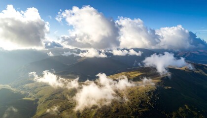 Obraz premium High-altitude view of mountain range shrouded in clouds