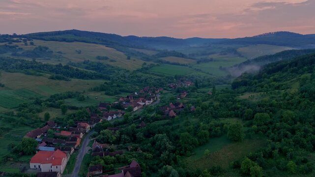 Aerial view of Crit village with the view at sunset. Transylvania village in Romania. Traditional village in the heart of Transylvania with old traditional houses and red roofs. Via Transilvanica 
