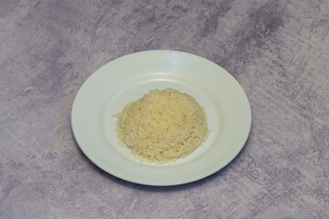 Cooked rice served on a white plate