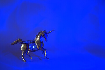 A unicorn figurine on a blue background.