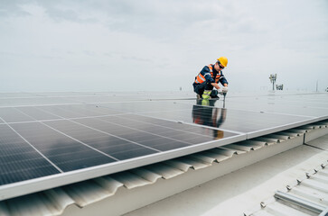 Solar panel technician working on photovoltaic system installation on rooftop during overcast day