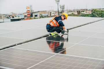 Worker installs solar panels on rooftop in urban area amidst cloudy weather