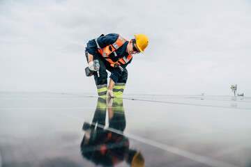 Worker installs solar panels on roof during cloudy afternoon in urban area