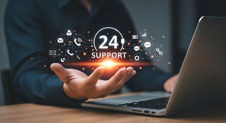 247 support concept with hand holding digital icons on laptop screen