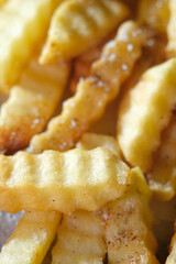 Close up of air fryer crinkle cut fries with salt