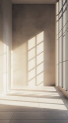Fototapeta premium Sunlight streaming through a large window in a minimalist empty room, casting long shadows on the wall and floor.