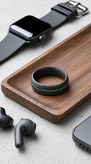 An innovative black smart ring sits atop a wooden tray, accompanied by sleek wearable devices.