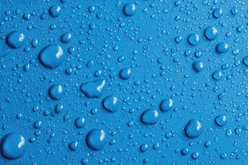 Close-up of water droplets on a blue surface