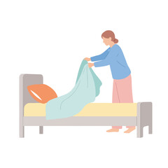 Woman making bed with blue covers and pink pillow in bedroom, making bed is her daily activity. Doing chores at home includes routine of making bed with comfort. Concept making bed in home life.