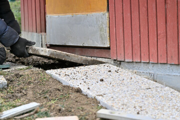 Laying stone paving around a house in the village in traditionally way