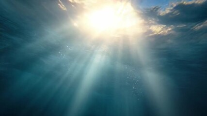 Sunlight Piercing the Azure: Beneath the waves, sunbeams cascade through azure waters, creating a serene and awe-inspiring underwater scene. Rays of light illuminate a tranquil aquatic realm. - Powered by Adobe
