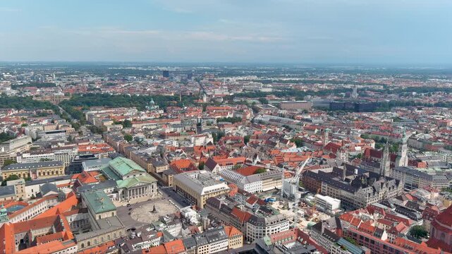 Captivating aerial drone footage showcasing Munich's historic landmarks, vibrant rooftops, and lush parks under soft daylight, capturing the essence of Bavaria&rsquo;s capital city in Germany.