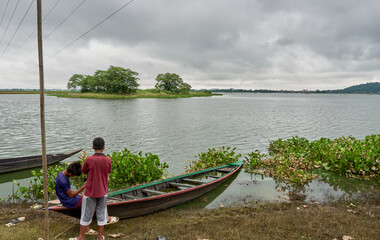 Children relaxing beside a lake