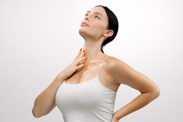 Beautiful woman with clear skin poses gracefully against a white background, showcasing her natural beauty and confidence, highlighting the essence of modern cosmetology and self-care practices