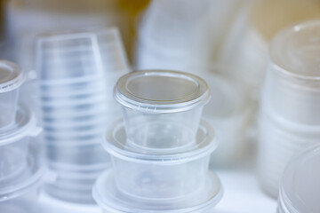 Clear plastic food storage containers with lids, photographed in a realistic style on a white background, representing food packaging concept
