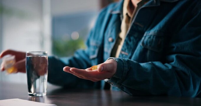 Pills, water and hands of man in home with medicine, prescription and adhd medication to focus. Health, student and person with container for vitamins, supplements and drugs for medical symptoms