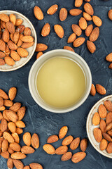 Almond oil with shelled almond nuts.