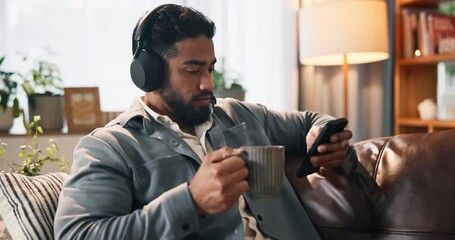 Coffee, streaming and phone with man on sofa for headphones, music playlist or relax. Audio subscription, calm podcast and connection with person in living room of home for album, sound and listening