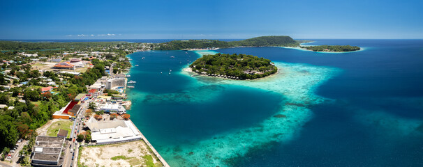 Aerial view of Iririki Island in Port Vila Harbour, Vanuatu, surrounded by turquoise lagoon, coral reefs, and tropical greenery in the South Pacific.