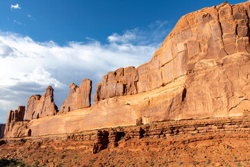 Fototapeta premium High walls of geological sandstone formation called Park Avenue in Arches National Park, Utah, USA with deep colors during last hours of sunshine of the day