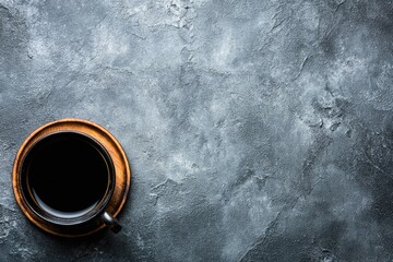 Dark coffee cup on textured gray surface