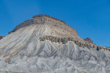 Low angle view of Mt. Garfield east of Grand Junction, CO, USA consisting of Mesaverde Group and Mancos Shale formations against a blue sky